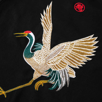 Close-up of back crane embroidery highlighting feather texture and crisp outlines