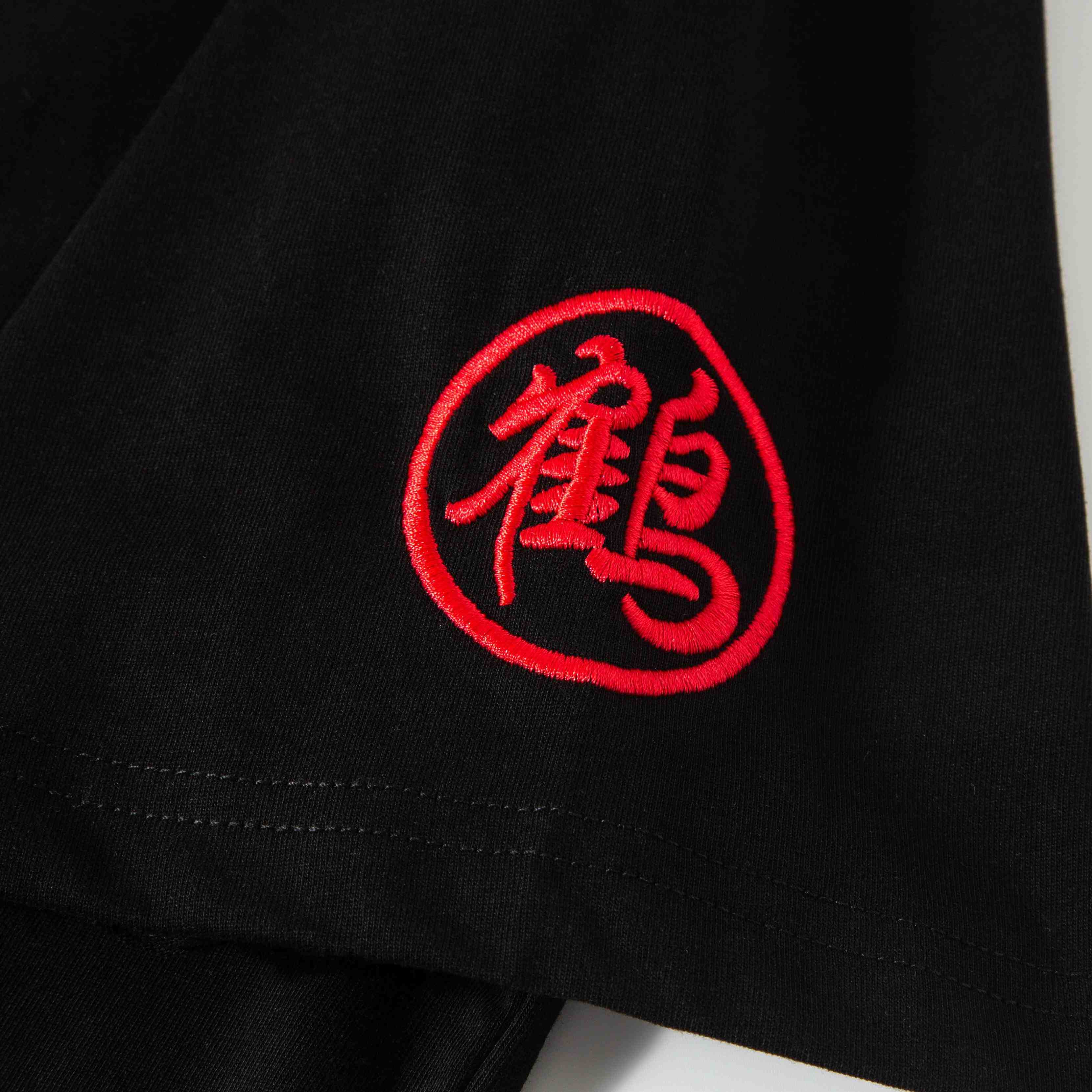 Sleeve detail with red embroidered seal character accent