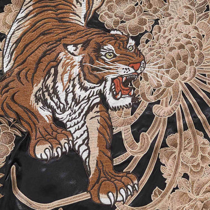 Close-up of roaring tiger with chrysanthemum petals on the sukajan jacket