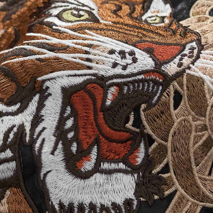 Macro close-up of tiger face stitching on the sukajan jacket