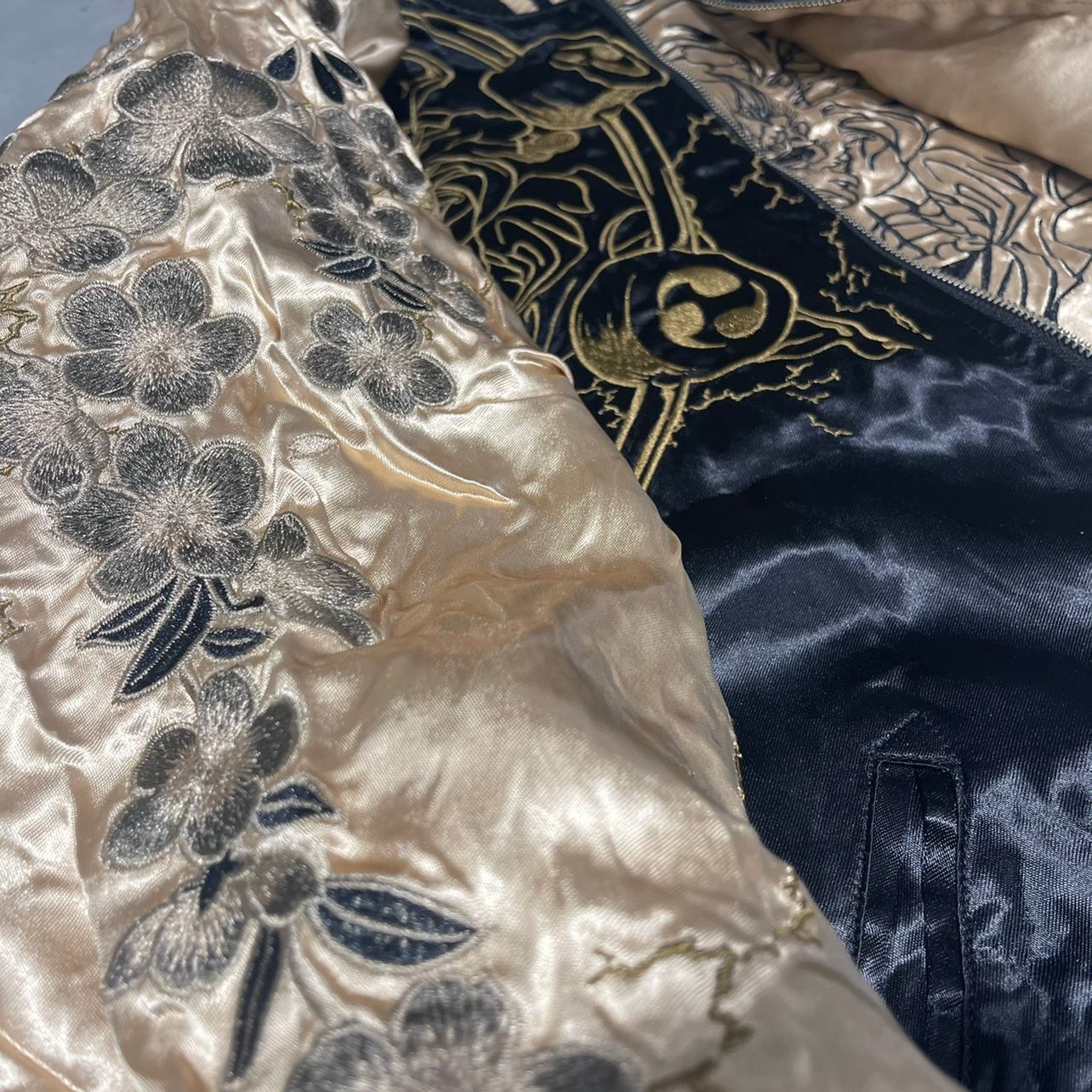 Sleeve close-up—sakura blossom embroidery panel on the beige color sukajan jacket.