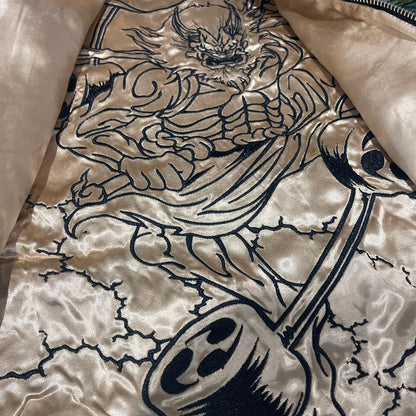 Inner lining artwork—outlined Raijin with drums and lightning on the reversible jacket.