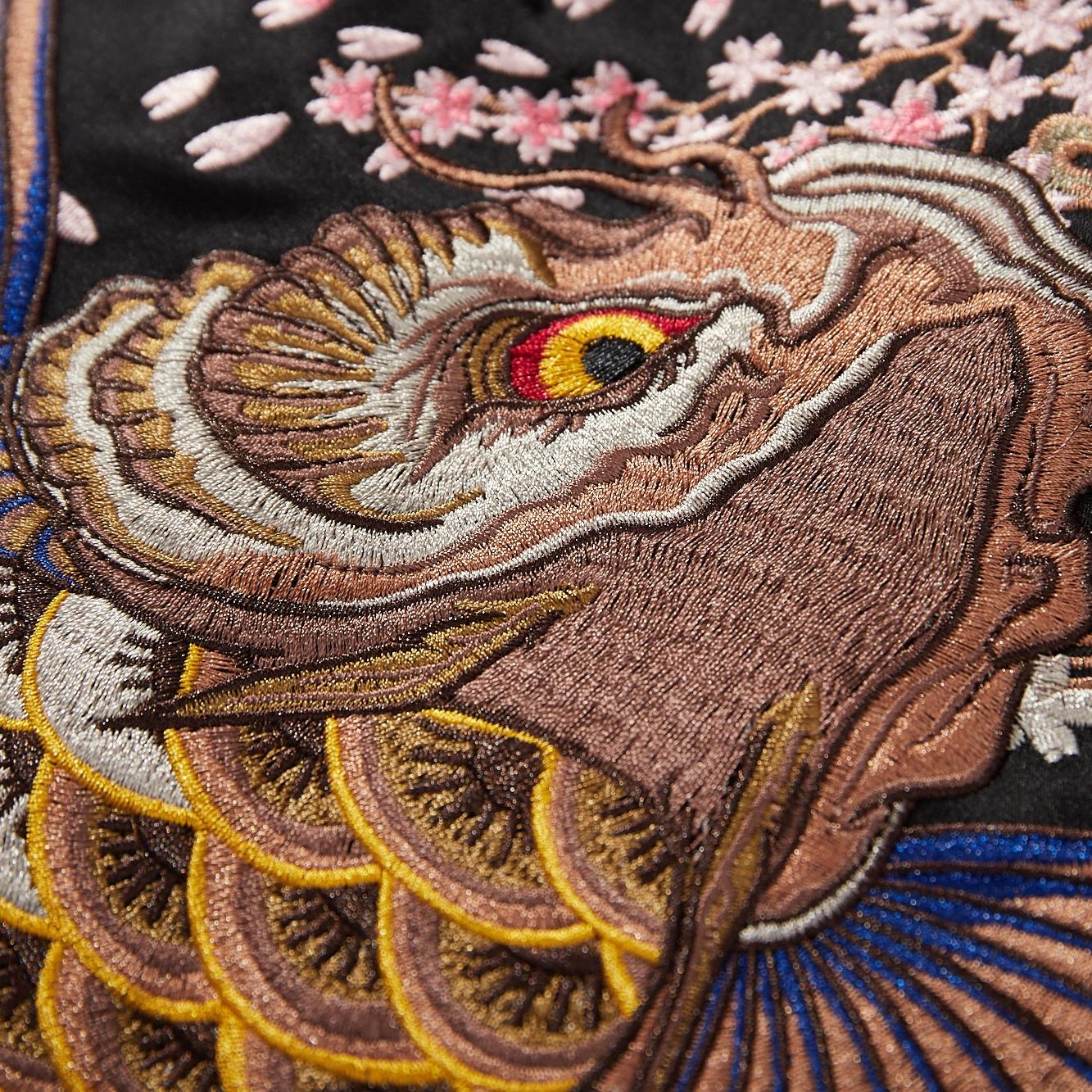 Close-up of koi head embroidery with layered threads and gradient scales
