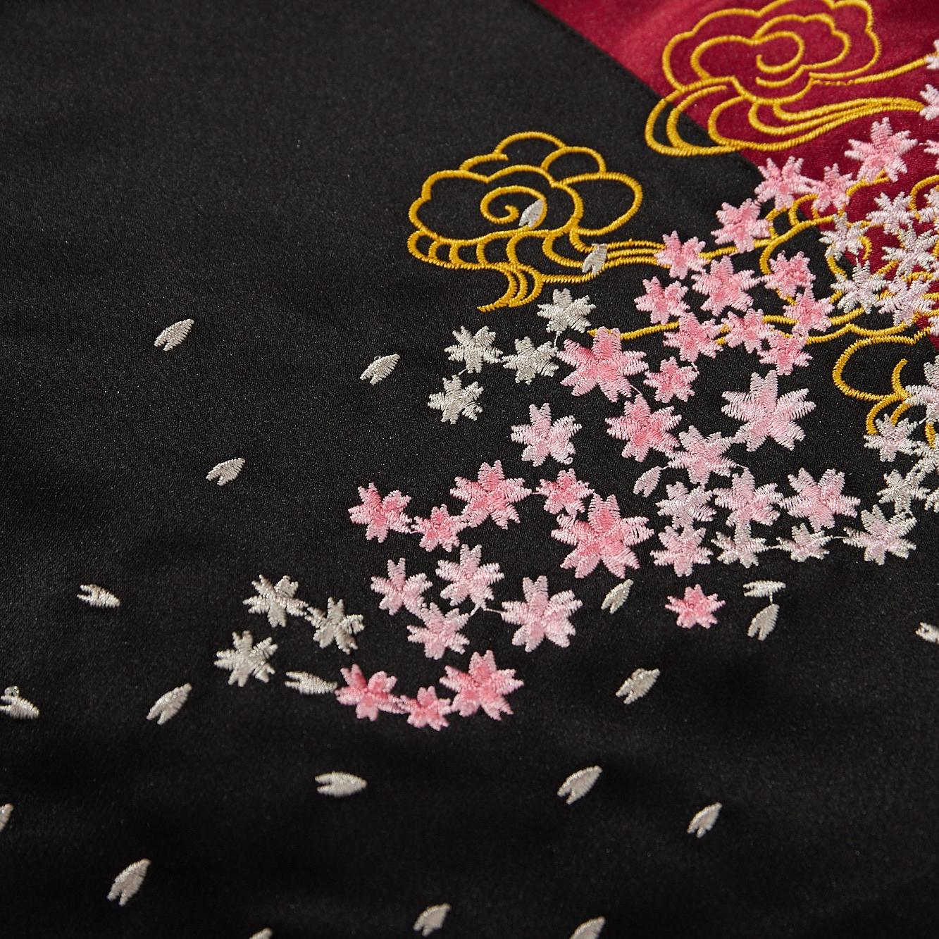 Cherry blossom embroidery detail with outlined cloud motifs
