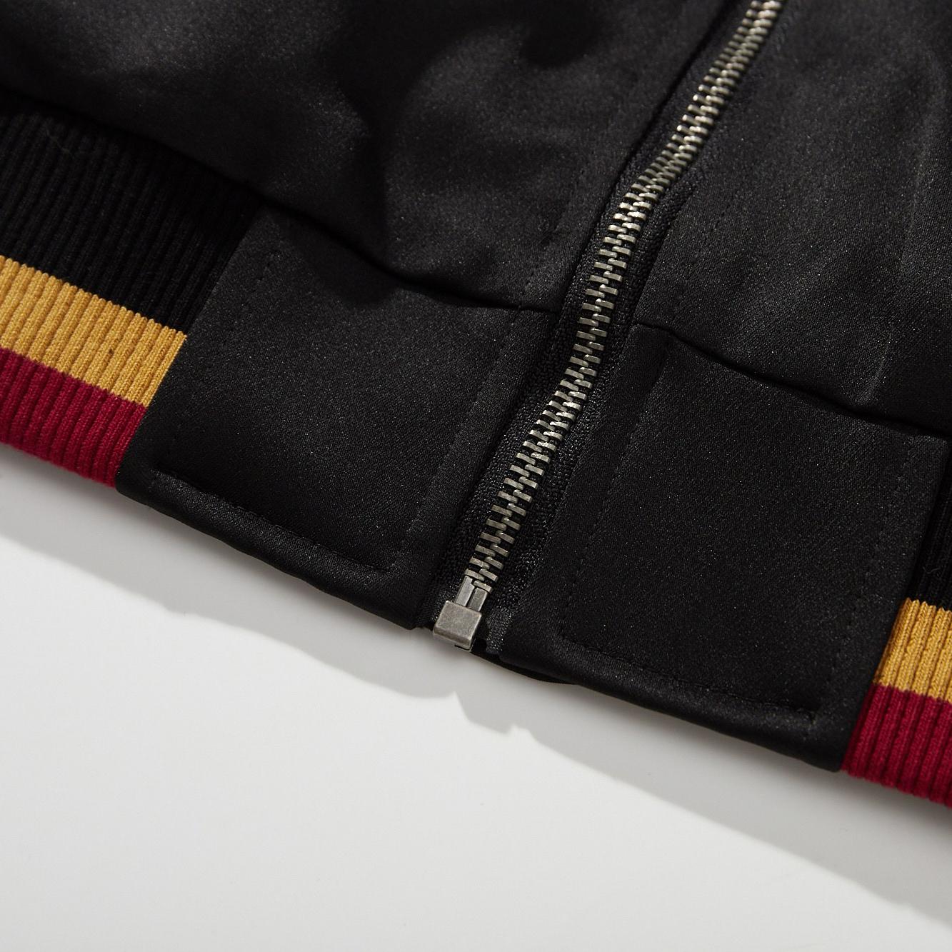 Bottom stop and hem detail showing the secure zipper end and reinforced waistband