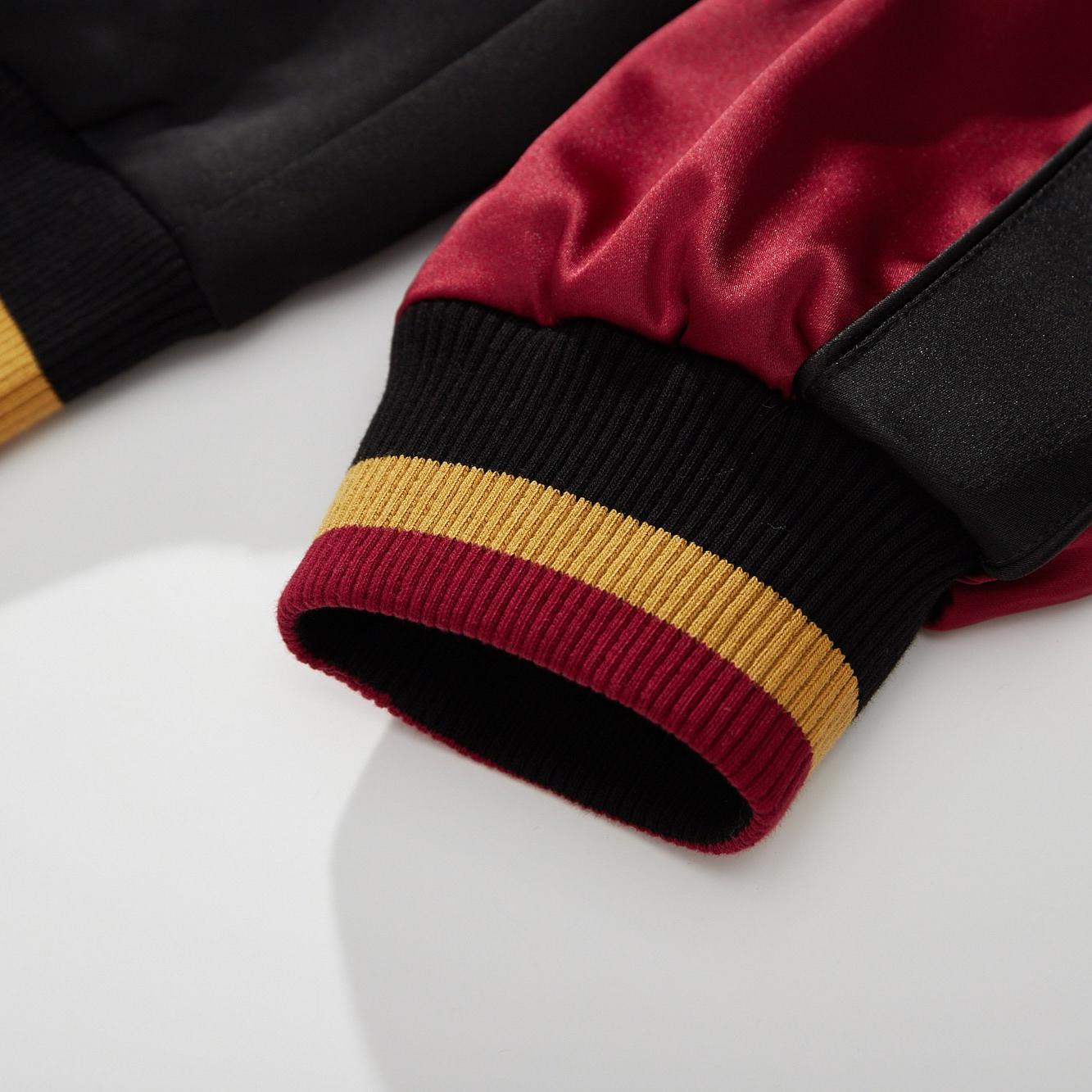 Ribbed cuff with red–gold stripes for a snug, comfortable fit