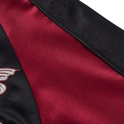 Satin sleeve panel detail with a contrast black side stripe