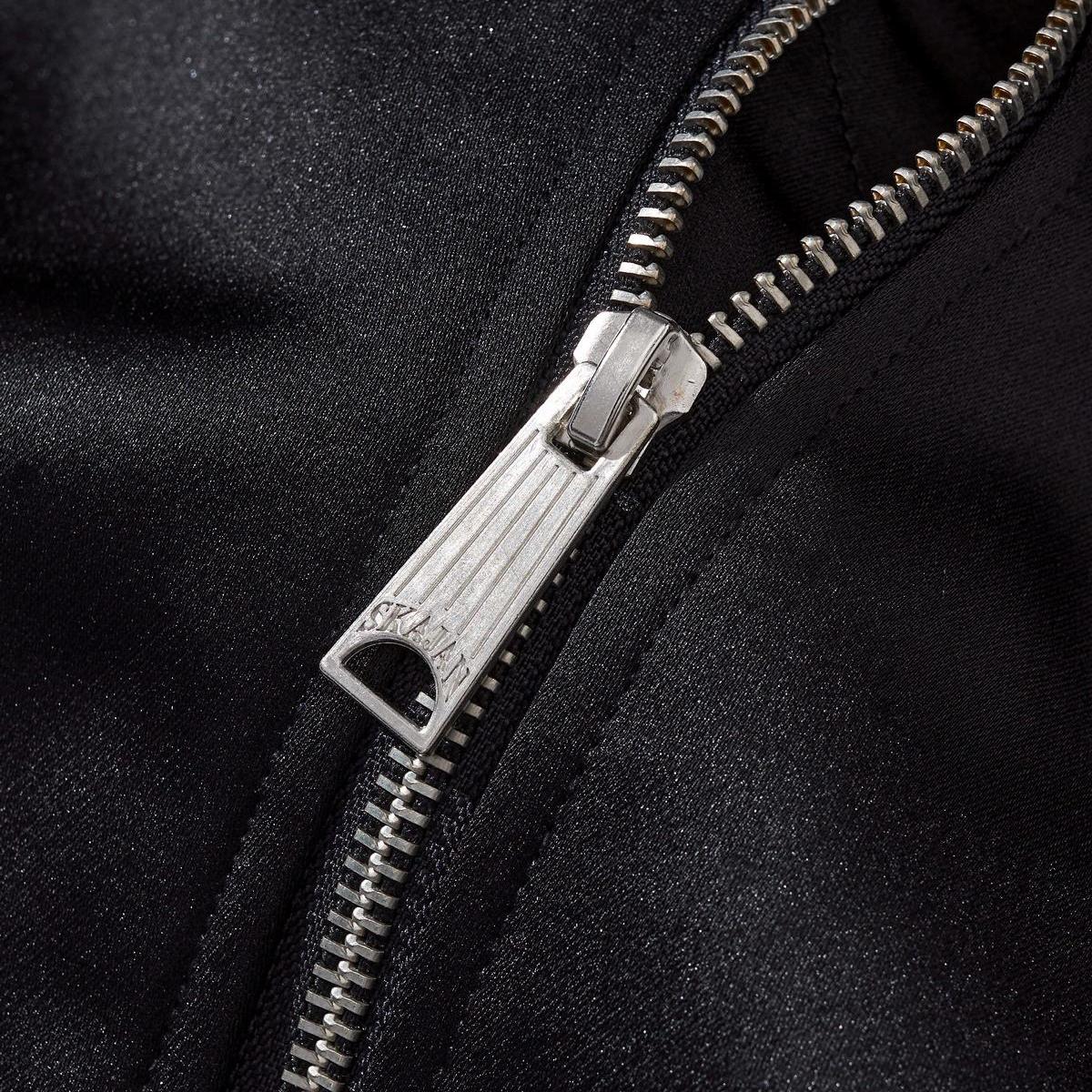 Close-up of the metal zipper puller with clean machining