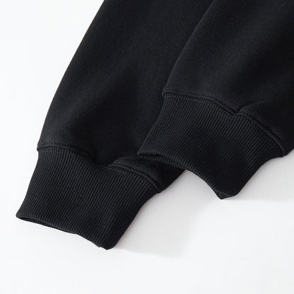 Ribbed cuffs close-up on the black sweatshirt showing stretch and dense knitting
