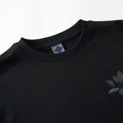 Ribbed crewneck detail of the black sweatshirt highlighting tidy construction