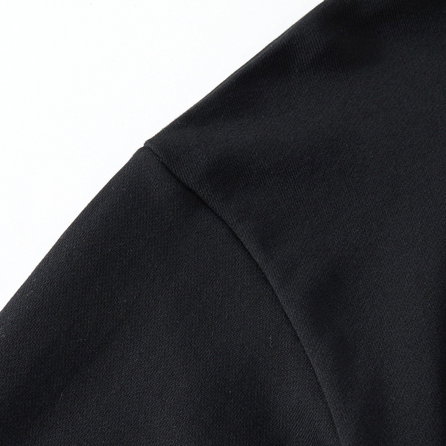 Shoulder seam detail on the black sweatshirt with smooth fabric and neat seams