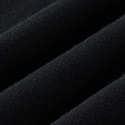 Fabric macro of the black sweatshirt displaying a soft, tight knit