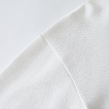Shoulder seam detail on the white sweatshirt highlighting smooth fabric and tidy seams