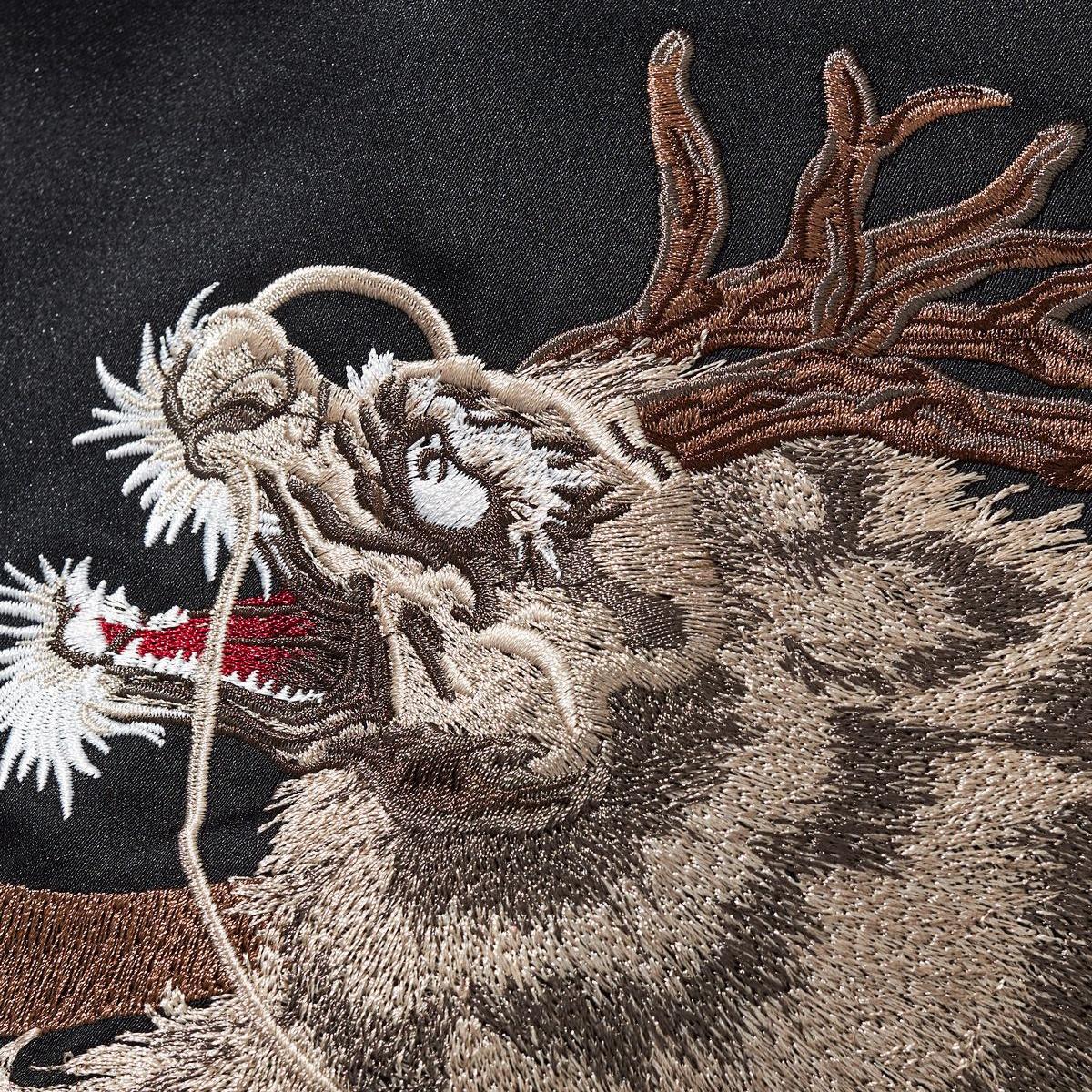 Kirin head embroidery close-up highlighting whiskers, horns, and layered stitches