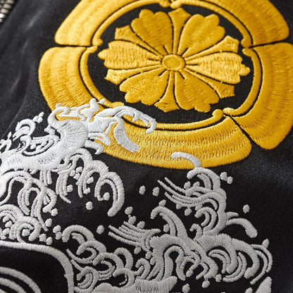 Close-up of the chest crest and wave embroidery showing raised satin stitches