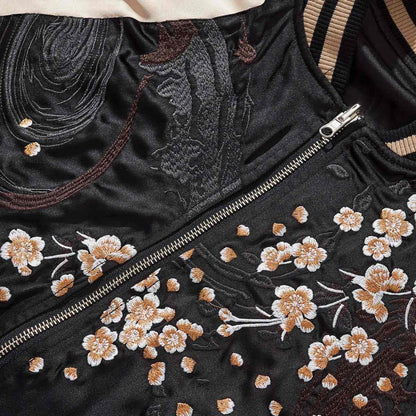Beige color sukajan jacket chest detail featuring sakura motifs beside the front zipper.