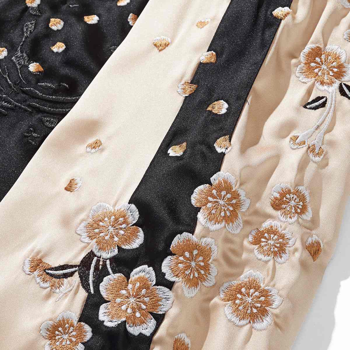 Beige color sukajan jacket sleeve panel with scattered sakura petals and contrast bands.