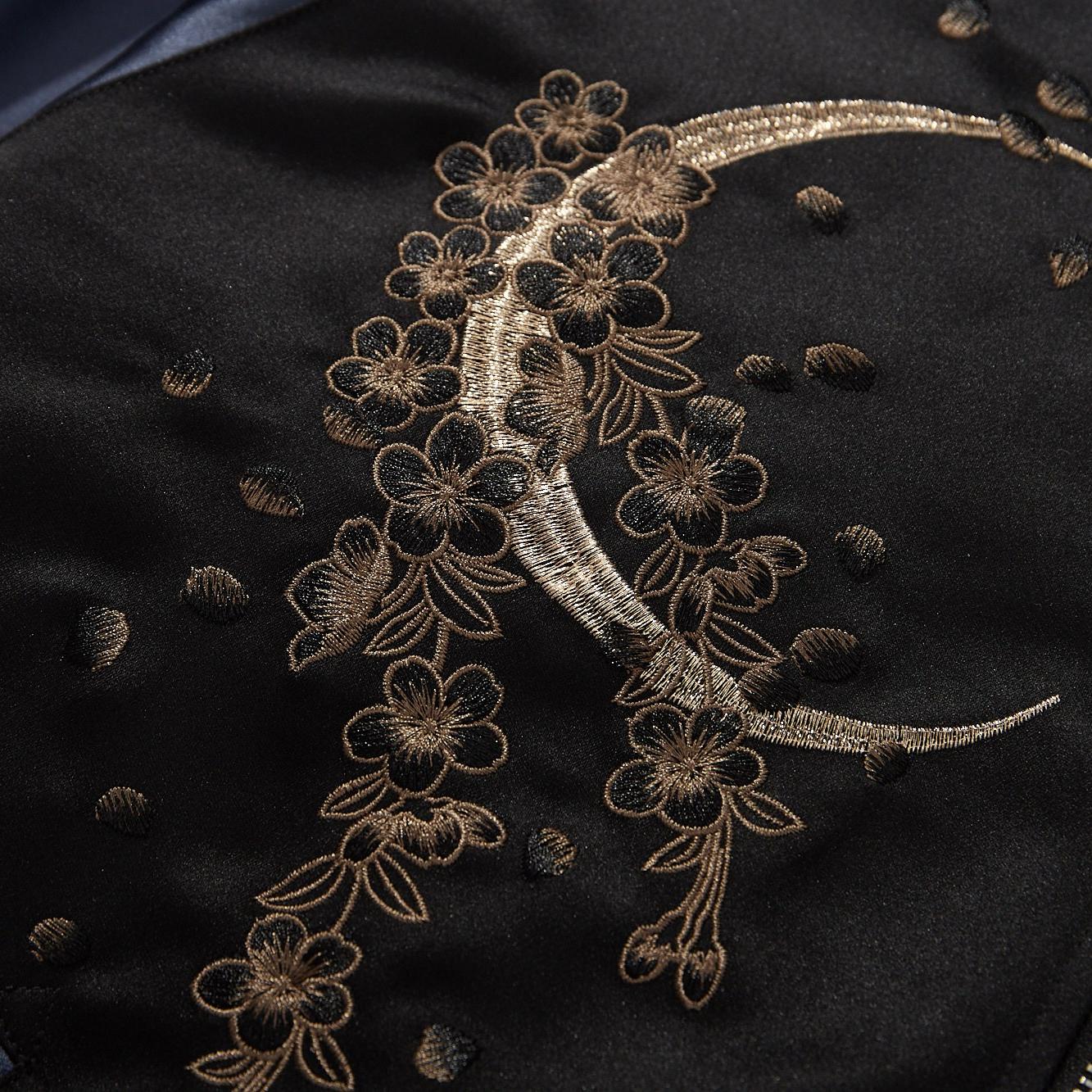 Crescent-moon and blossoms embroidery close-up on the chest