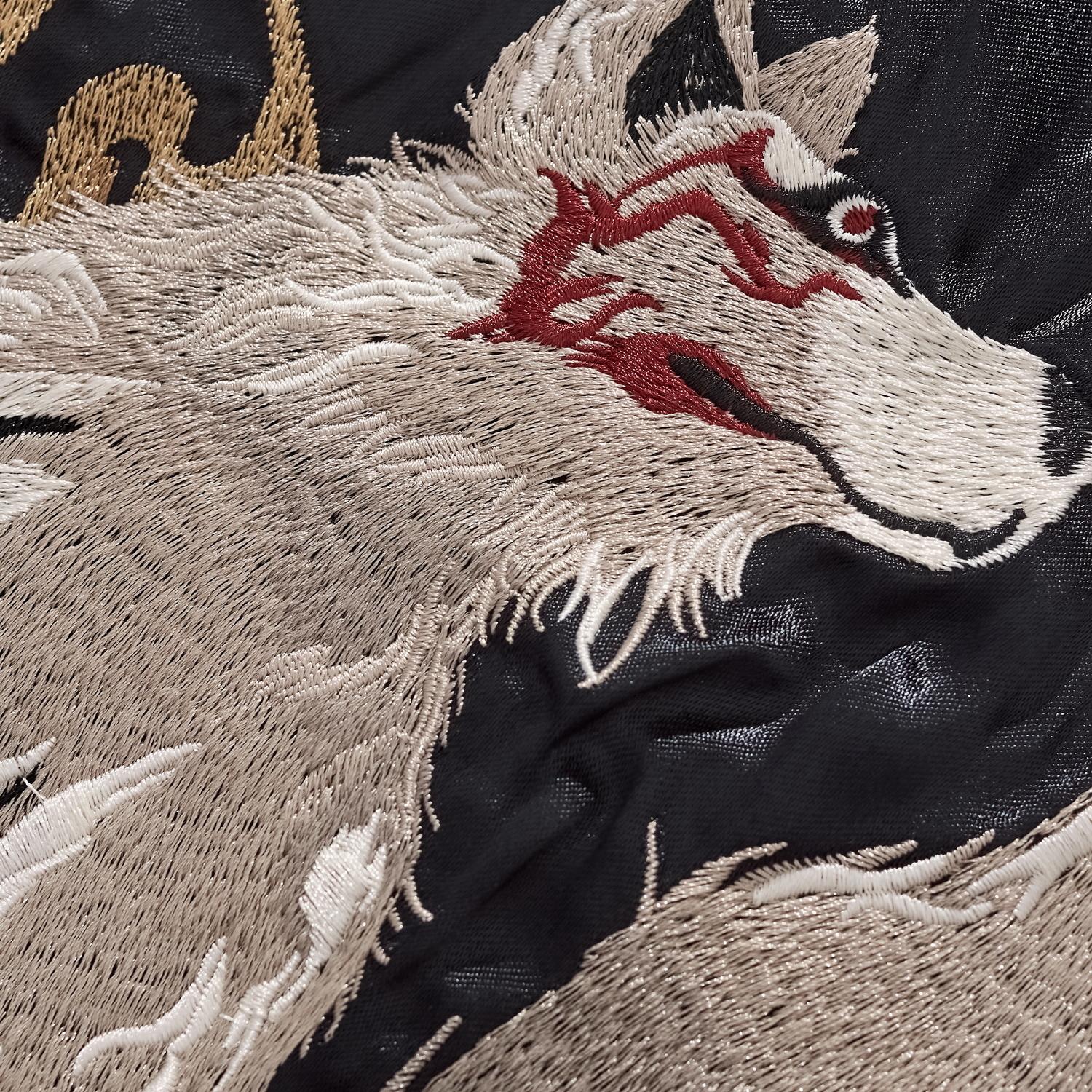 Macro shot of the Nine-Tailed Fox embroidery showing detailed fur texture and red facial markings.