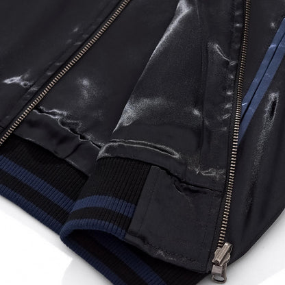Close-up of the ribbed hem and zipper base showing the blue side panel construction.