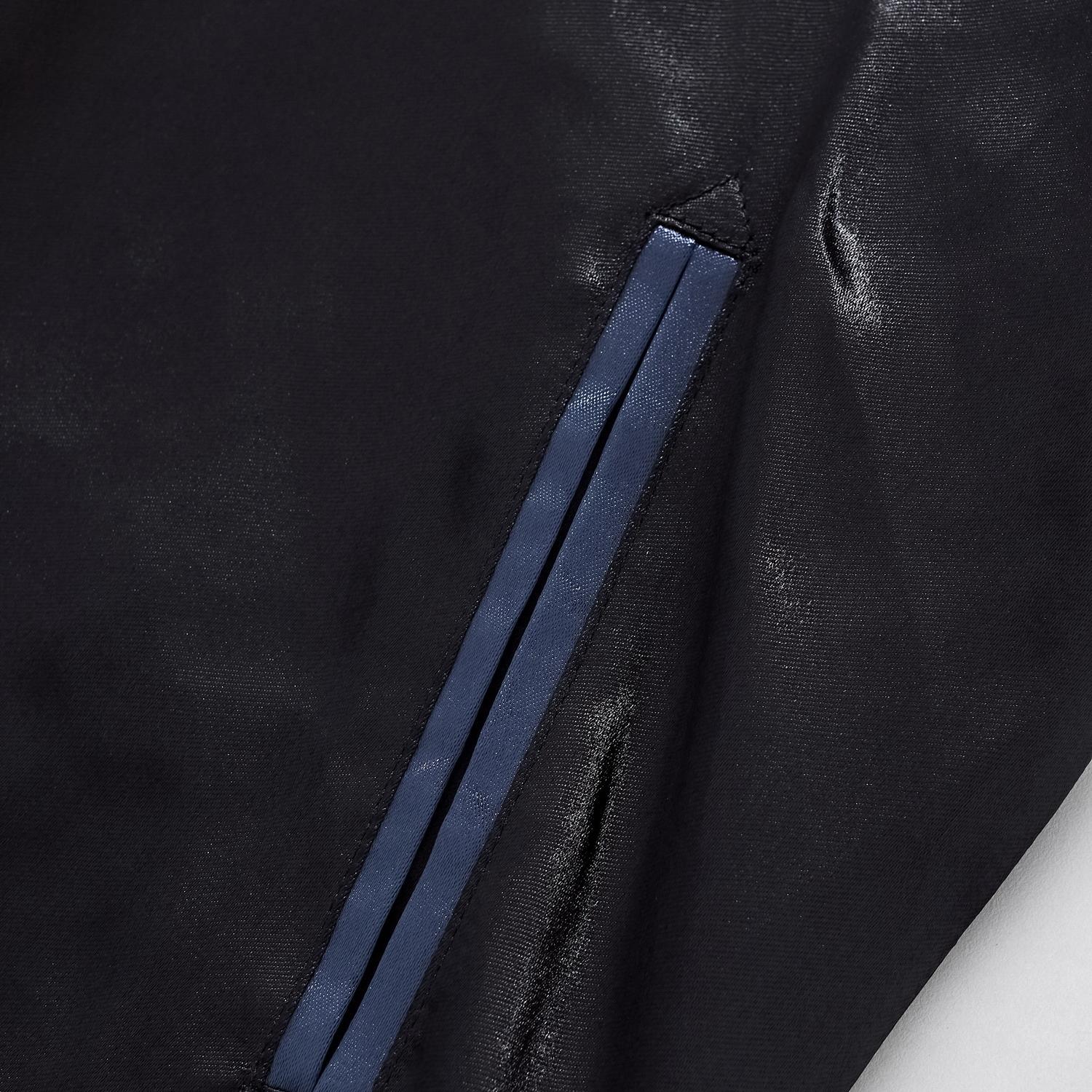 Close-up of the reinforced side welt pocket with blue trim on the midnight blue jacket.