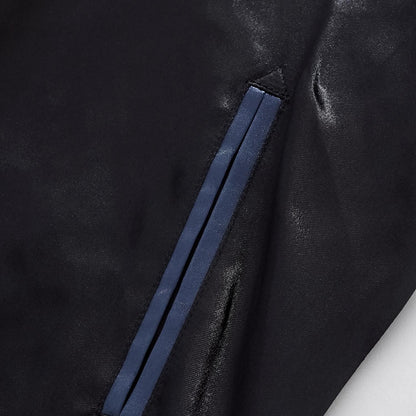 Close-up of the reinforced side welt pocket with blue trim on the midnight blue jacket.