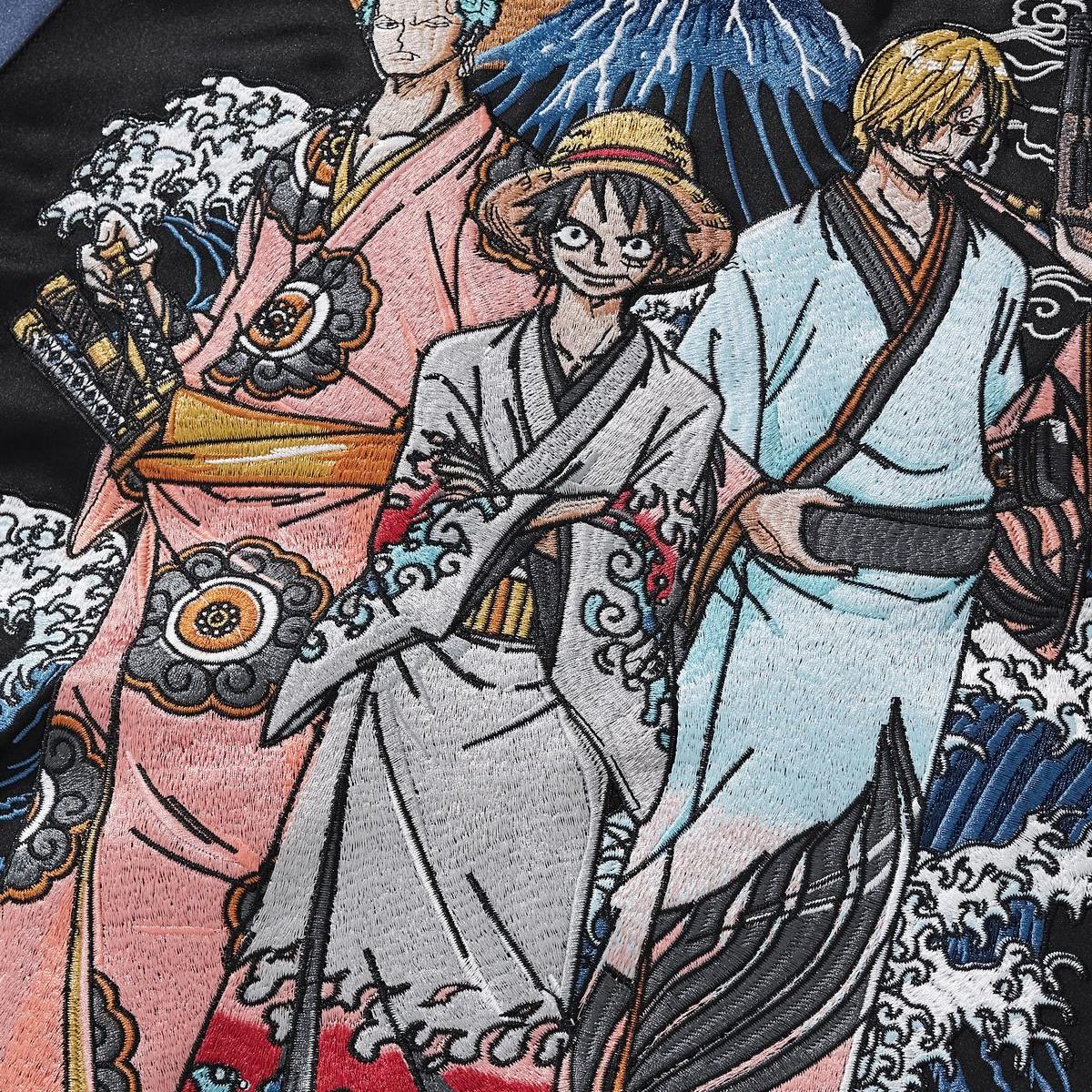 Close-up of kimono trio embroidery with wave outlines