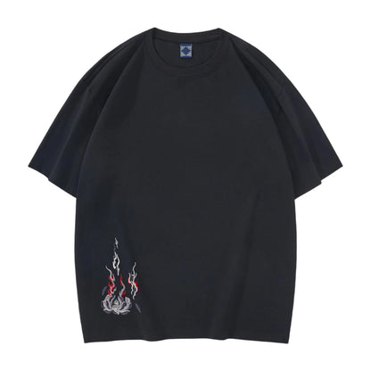 Front view of black cotton streetwear T-shirt with minimalist burning lotus embroidery on the lower hem.