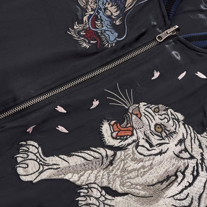 Front chest view showing the White Tiger and Azure Dragon embroidery facing each other across the zipper.