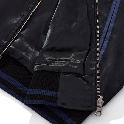 Close-up of the ribbed hem and zipper base showing the premium blue rayon fabric texture.