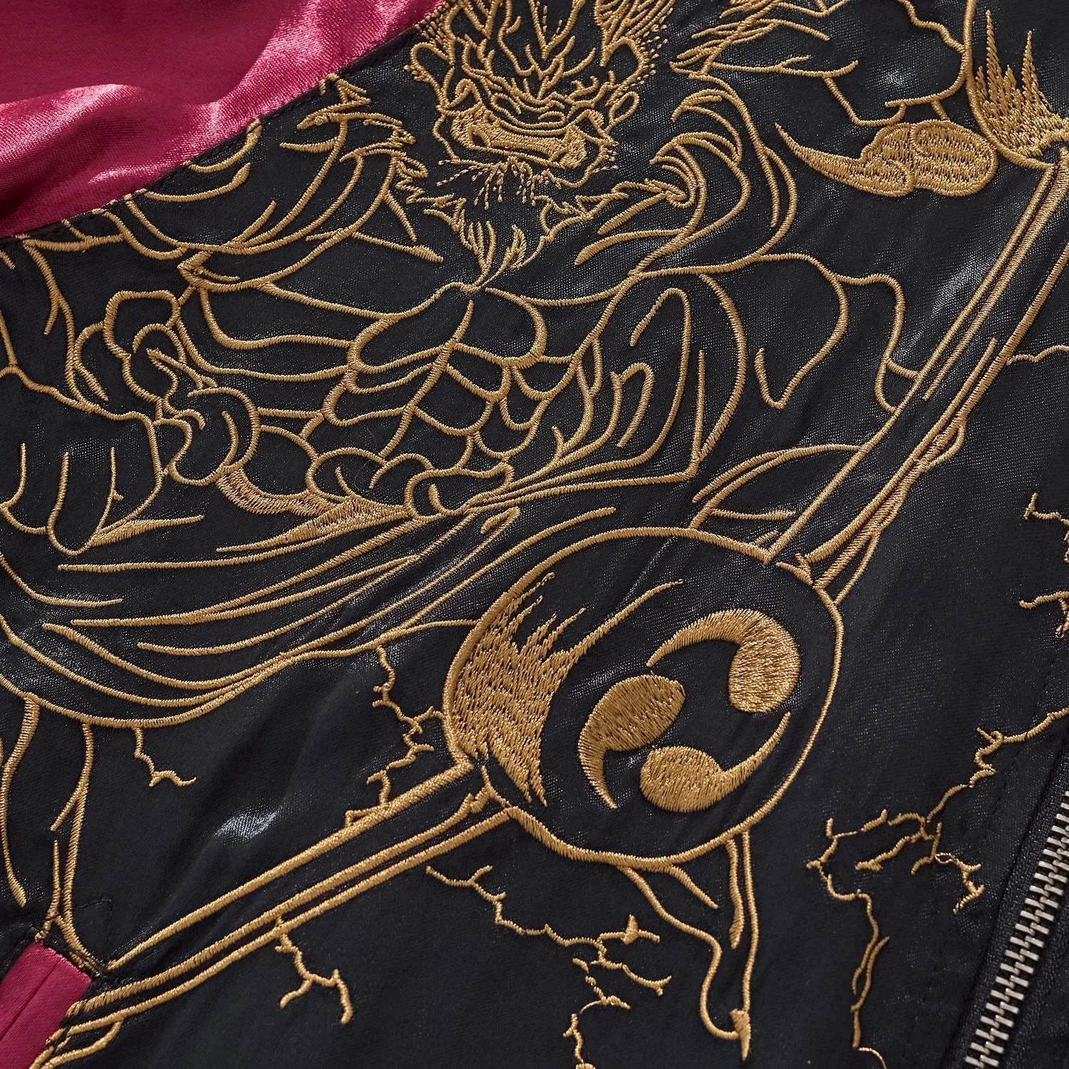 Detail of the golden Wind and Thunder God chest embroidery on the burgundy rayon jacket.