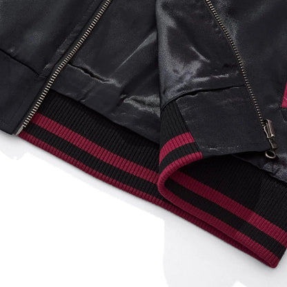 Close-up of the ribbed hem and zipper base showing the burgundy rayon interior lining.