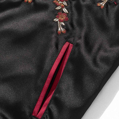 Front pocket detail on burgundy color reversible dragon & peony sukajan jacket with red welt and floral embroidery.