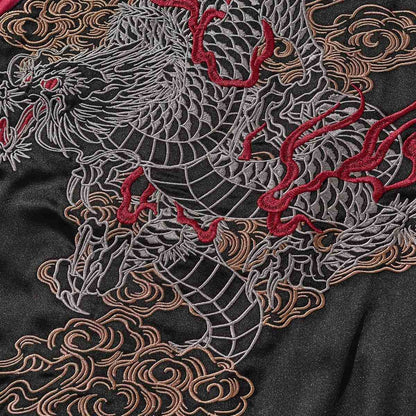 Back embroidery detail—line-art dragon with flame accents and rolling clouds.