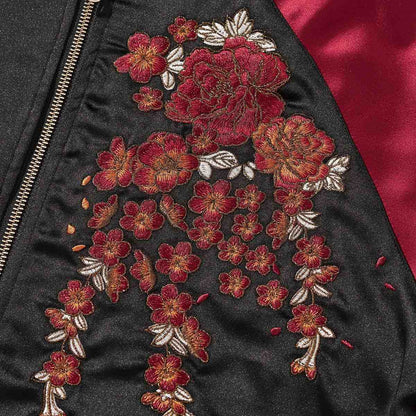 Chest detail—peony cascade embroidery beside the zipper.