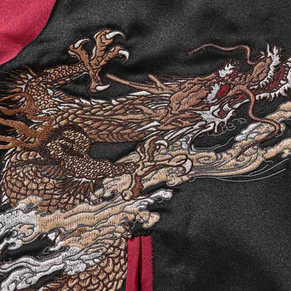 Close-up of dragon head and claw with billowing clouds—dense satin stitching.