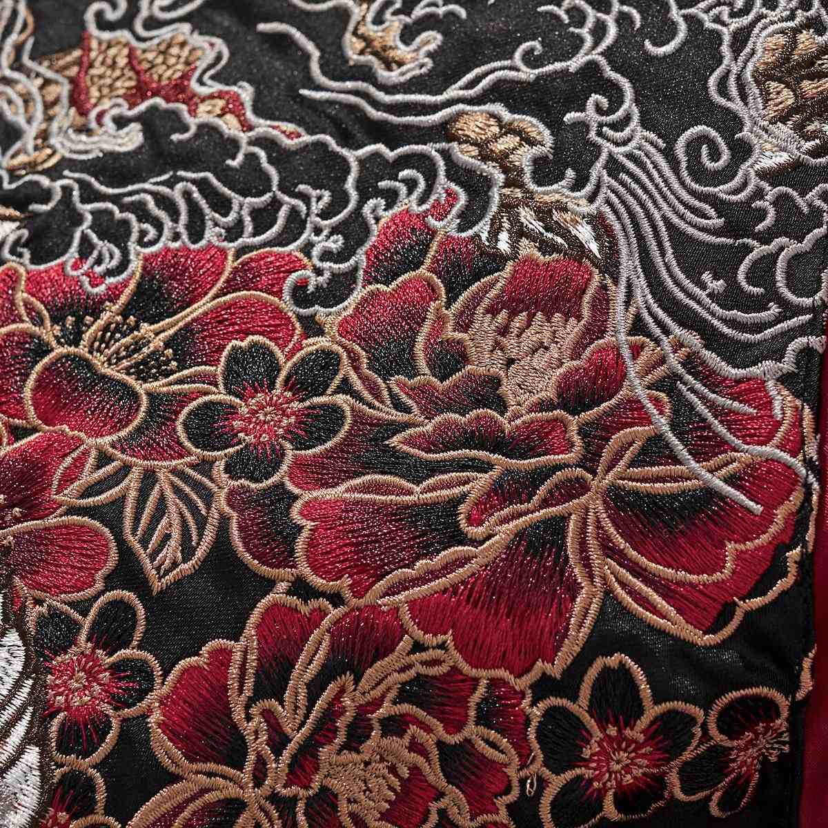 Close-up of layered peony blossoms embroidery with fine outlines.