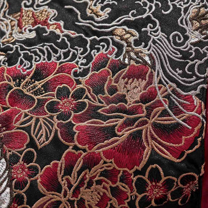 Close-up of layered peony blossoms embroidery with fine outlines.