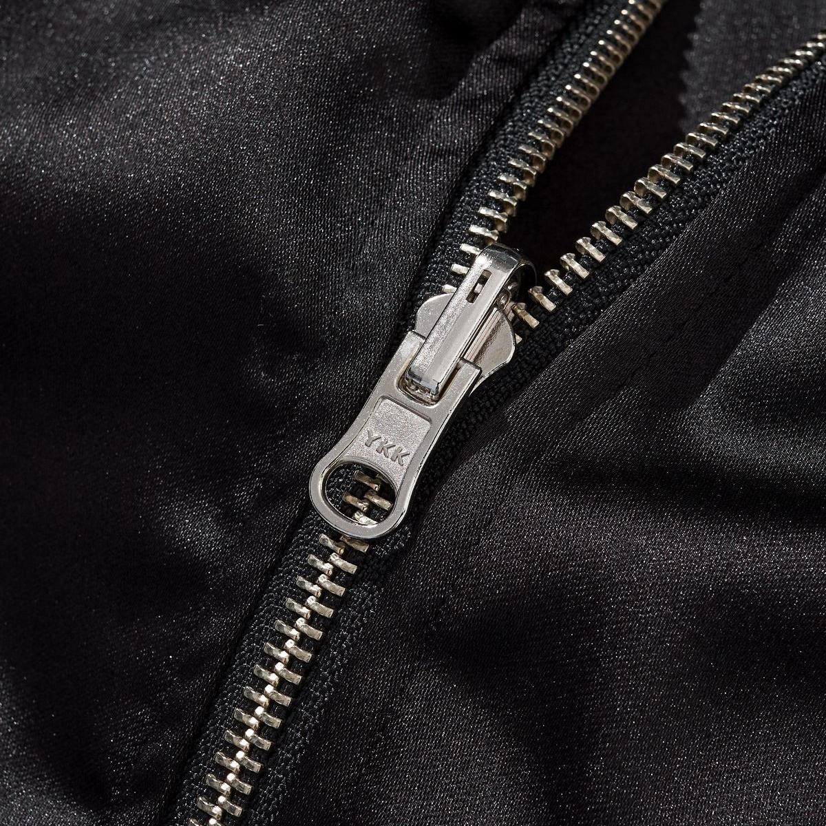 Close-up of the metal zipper with smooth satin fabric