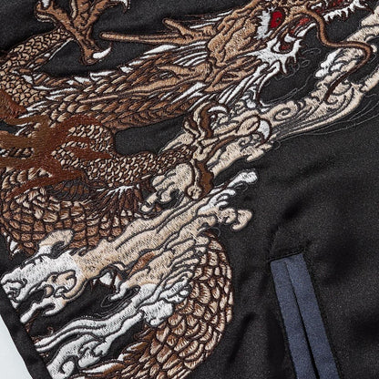 Close-up of dragon body embroidery with layered scales and swirling clouds