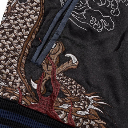 Dragon tail and flames near the pocket opening, densely stitched