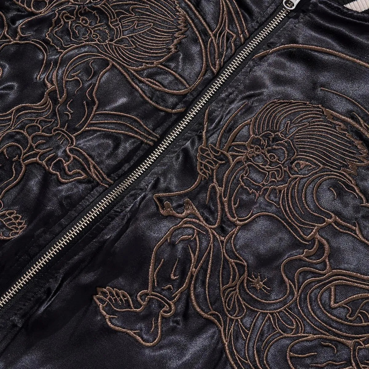 High-density chest embroidery detail featuring the Japanese Wind and Thunder Gods.