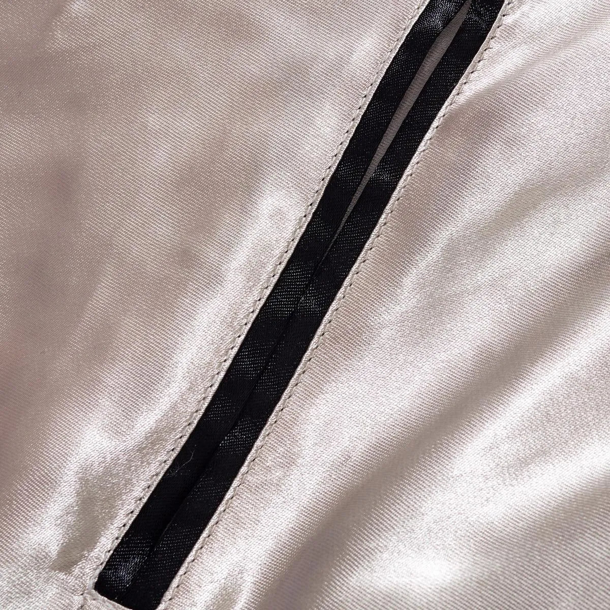 Detail of the reinforced welt pocket on the minimalist reverse side of the jacket.