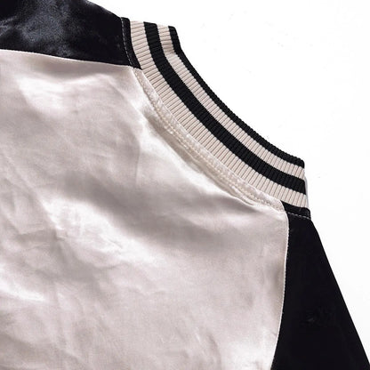 Close-up of the raglan sleeve construction and ribbed collar from the back view.