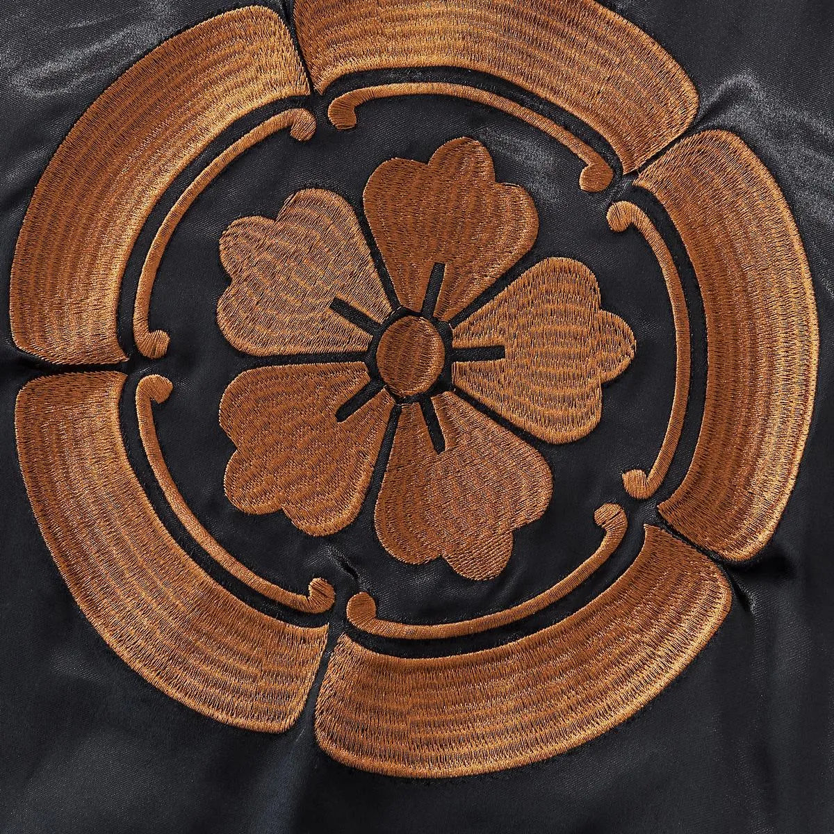 Detailed embroidery shot of the golden Oda Clan (Mokkou) crest.
