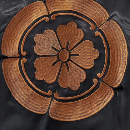 Detailed embroidery shot of the golden Oda Clan (Mokkou) crest.