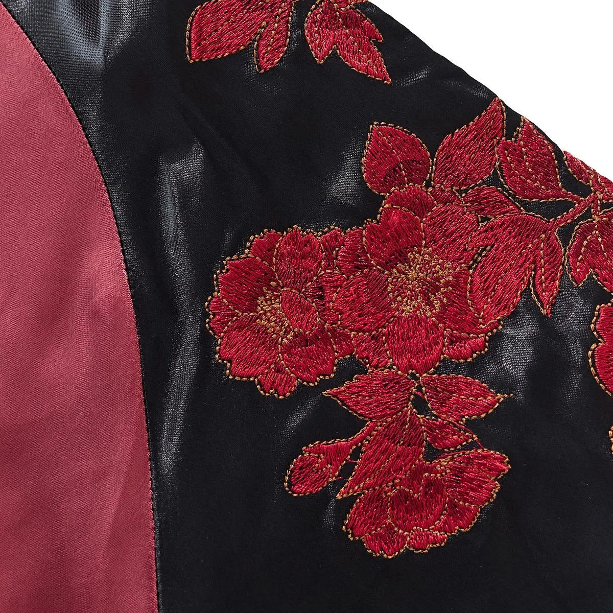 Detailed shot of the red peony flower embroidery on the black satin shoulder area.