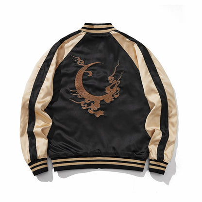 Bronze crescent-and-cloud emblem centered on a reversible sukajan jacket, back view, side B, beige.