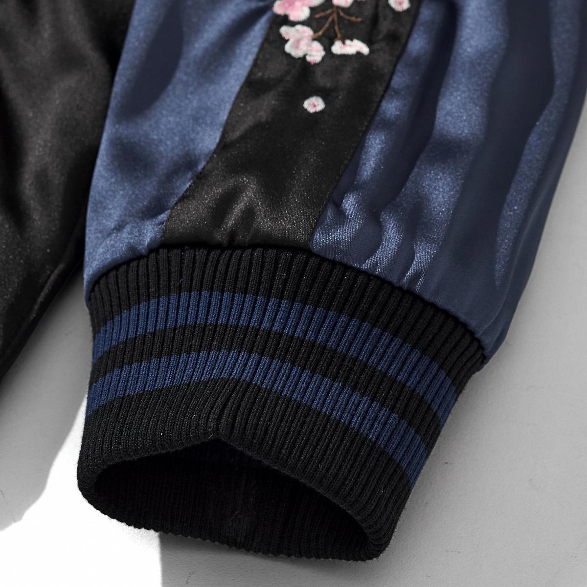 Reversible Kirin & Crescent Sukajan Jacket — ribbed cuff close-up with sakura embroidery on the sleeve panel.