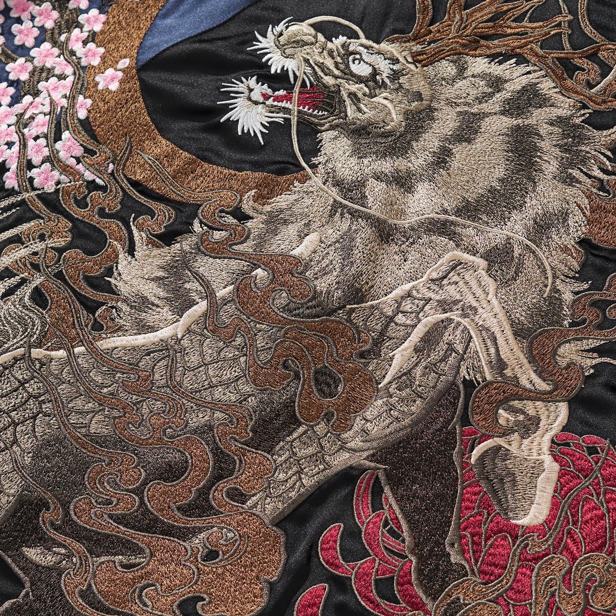 Textured embroidery of the large kirin body with smoke swirls over red chrysanthemum